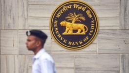 A security person walks past the RBI Headquarters in Mumbai on Monday ahead of a crucial board meeting