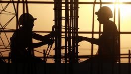 Labourers work at the Dwarka Expressway construction site