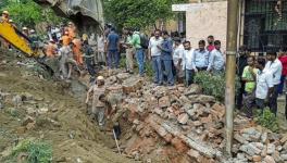 Rescue operation underway after a portion of a boundary wall of a housing society collapsed, at Jal Vayu Vihar in Noida