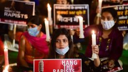 Women hold a candlelight vigil demanding justice for Hathras victim, in New Delhi. PTI File Photo