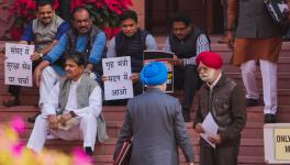 Suspended MPs protest against their suspension at the entrance of Parliament during ongoing Winter session, in New Delhi, Monday, Dec. 18, 2023. (PTI Photo/Kamal Singh) (PTI12_18_2023_000079B)