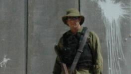 Israeli Soldier in front of wall.jpg