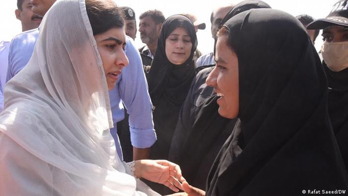Malala Yousufzai speaks with women and children about facing the tough situation with courage