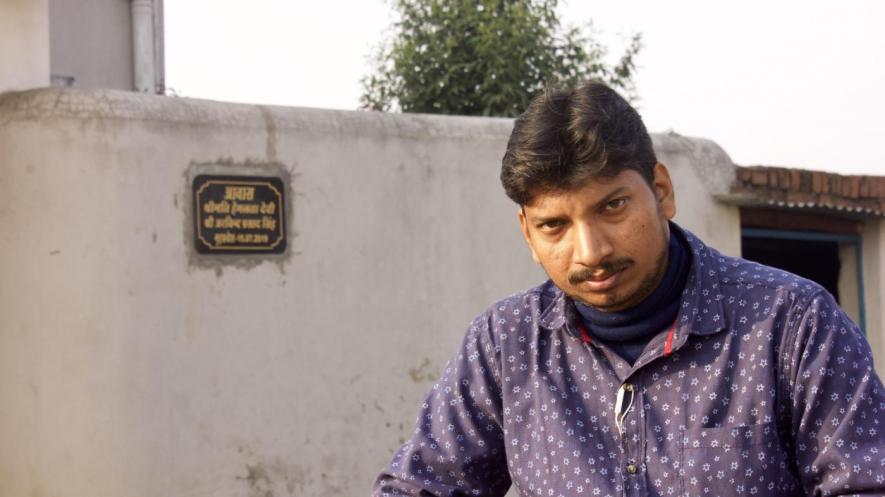 Rupesh Singh in front of his residence in Ramgarh. Image Courtesy: Twitter/@Article14live